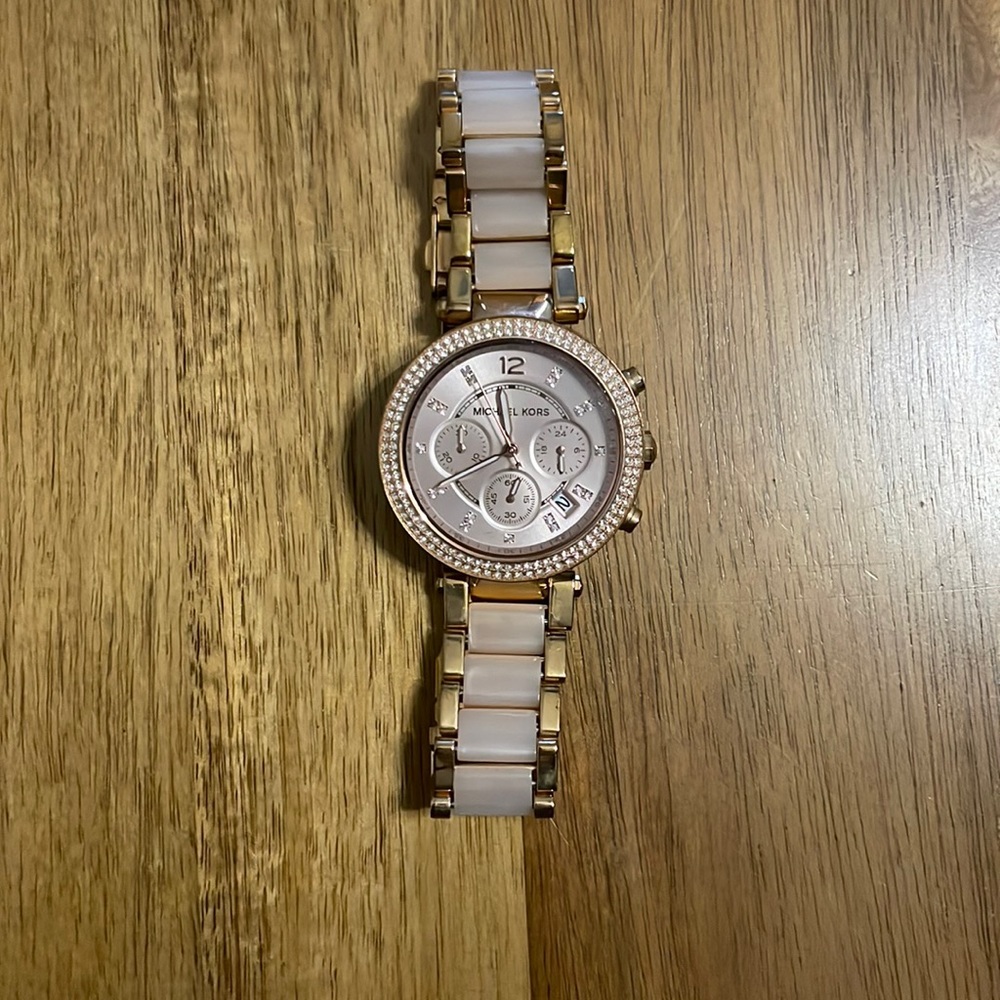 Michael Kors rose gold watch. About 4 inches in length